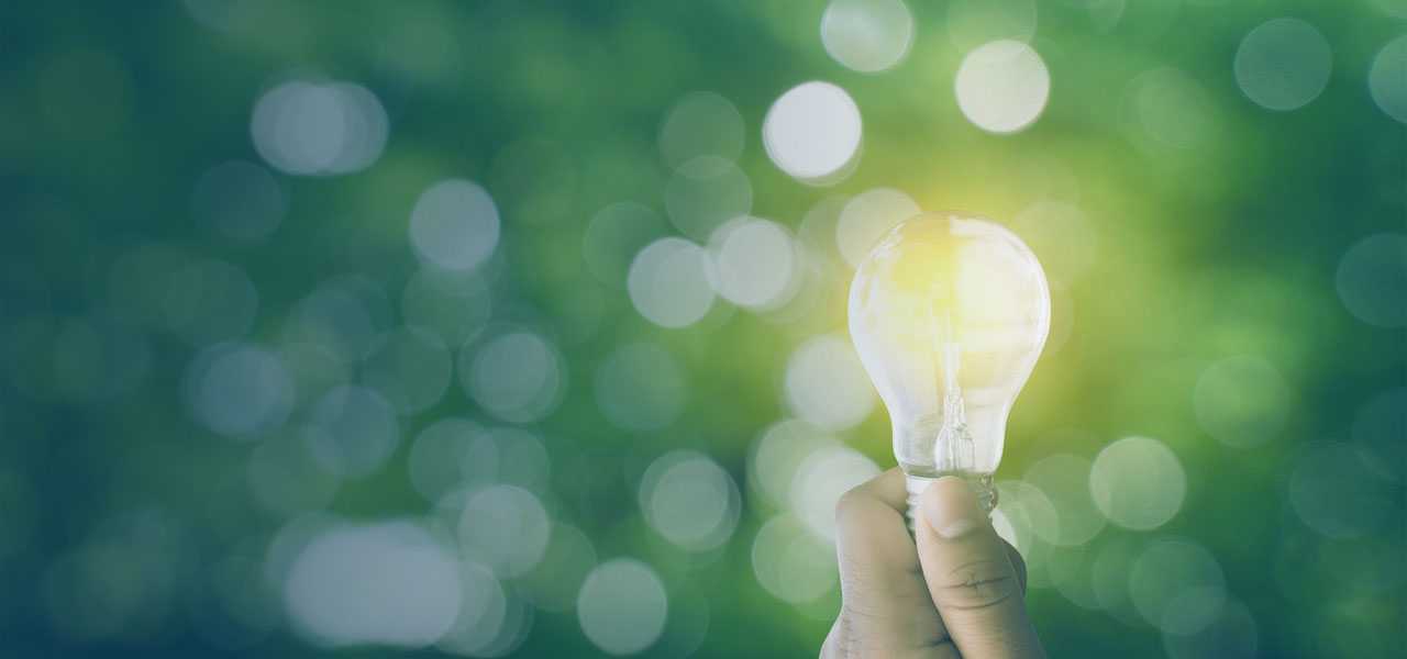 Holding a lit lightbulb